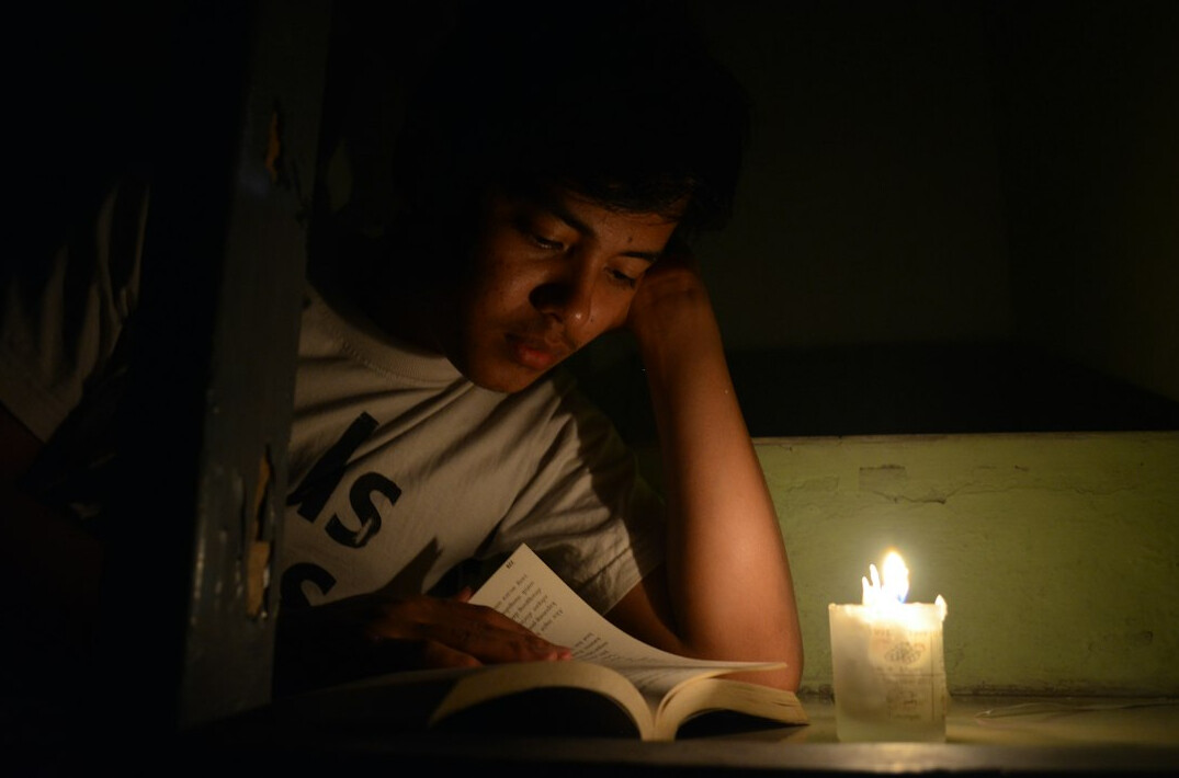 person reading mystery book at night